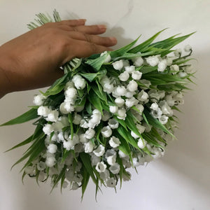 A wedding bouquet collection of pure white artificial lily of the valley flowers