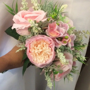 A wedding bouquet of artificial silk pink roses peony