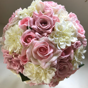 an artificial bridal bouquet of pink roses and ivory dahlia