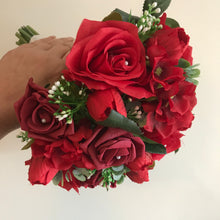 a wedding bouquet of artificial red silk roses & tulip flowers