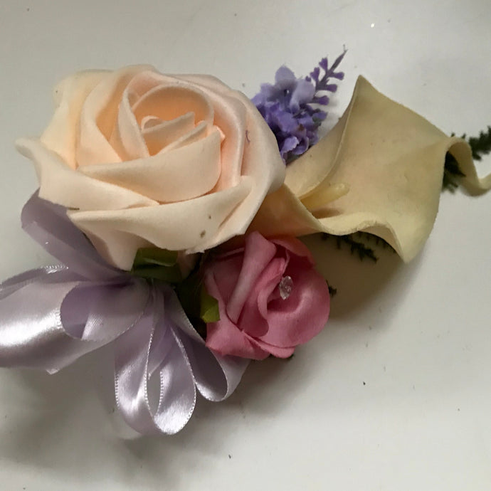 wedding corsage features ivory, pink foam rose, calla lily and lavender
