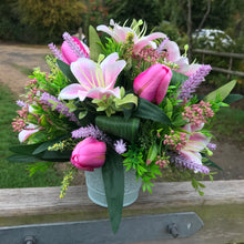 A flower arrangement in metal container
