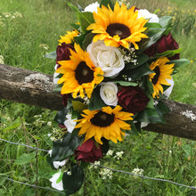 A bouquet collection of artificial roses and sunflowers