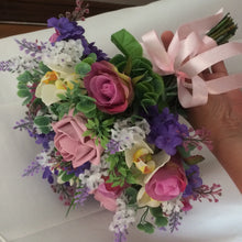 A collection of wedding bouquets featuring artificial purple and pink flowers