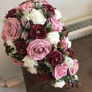 A teardrop bouquet of artificial burgundy, ivory & pink roses, crystals & pearls