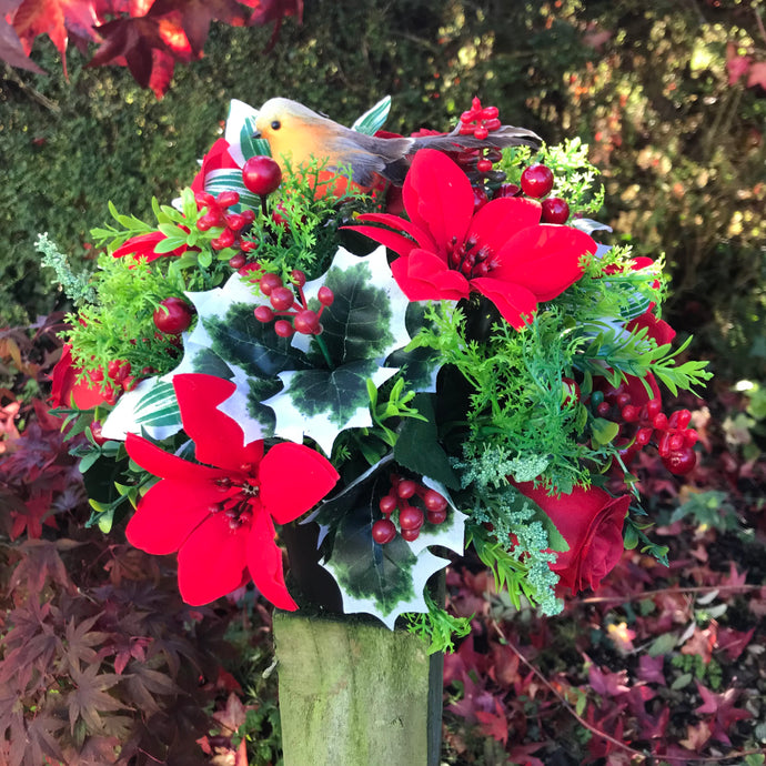 a Christmas memorial grave side pot with artificial silk flower arrangement