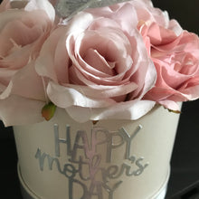 A large pink rose flower arrangement in ivory hat box