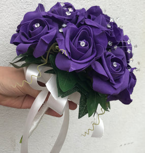 a wedding bouquet of artificial purple foam roses with diamante centres