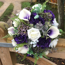 A wedding bouquet of ivory and purple silk flowers