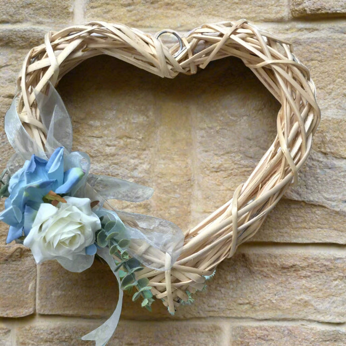 A wicker wreath with blue flower arrangement