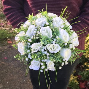 A collection of wedding bouquet featuring ivory roses and gyp