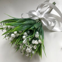 A wedding bouquet collection of pure white artificial lily of the valley flowers