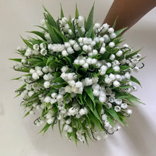 A wedding bouquet collection of pure white artificial lily of the valley flowers