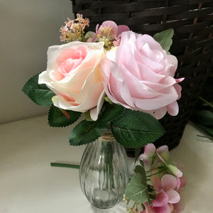 an arrangement of artificial pink flowers