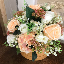 Gold hat box featuring peach and cream flowers