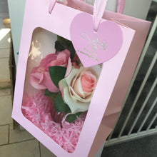 A small posy arrangement of pink silk roses