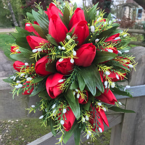 an artificial shower bouquet featuring red silk tulips