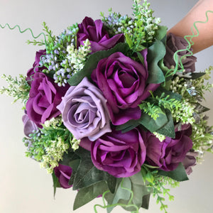 an artificial wedding bouquet of purple flowers