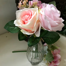 A posy of roses and hydrangea in glass vase