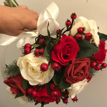 A Christmas wedding bouquet of artificial red and ivory roses