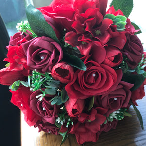 a wedding bouquet of artificial red silk roses & tulip flowers