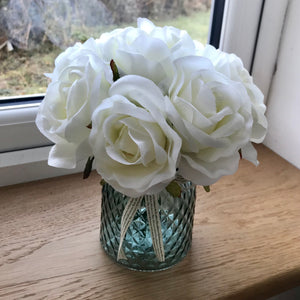 ivory rose in blue cut glass vase