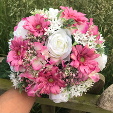 A wedding bouquet of artificial pink and ivory roses & gerbera flowers