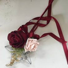 a bridesmaids star wand with mocha pink roses and burgundy rose