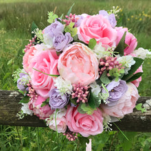 pink roses and peonies feature in this bridal bouquet