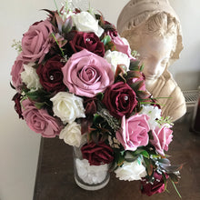 A teardrop bouquet of artificial burgundy, ivory & pink roses, crystals & pearls