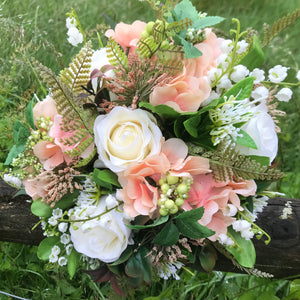 A wedding bouquet of artificial silk ivory & peach roses & hydrangeas