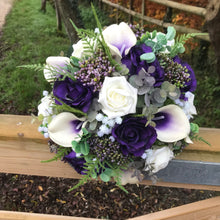 A wedding bouquet of ivory and purple silk flowers