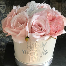 A large pink rose flower arrangement in ivory hat box