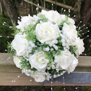 A teardrop bouquet collection of artificial ivory foam roses and gysophila