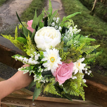 A wedding bouquet featuring dusky pink gerbera and roses