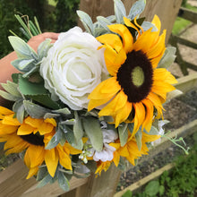 a brides bouquet of artificial sunflowers daisies and roses