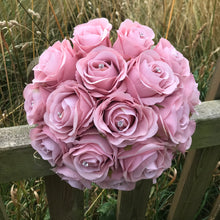 A wedding bouquet of dusky pink artificial flowers