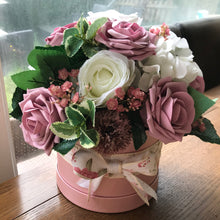 dusky pink artificial flowers in hat box