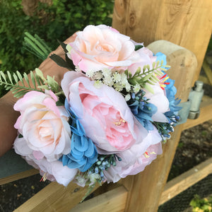 A bouquet of pale pink and blue flowers