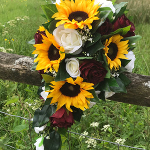 A bouquet collection of artificial roses and sunflowers