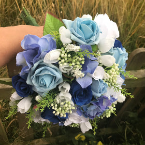 A brides bouquet of blue & white and ivory silk flowers