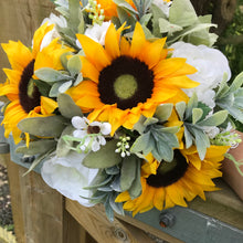 a brides bouquet of artificial sunflowers daisies and roses