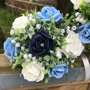 a wedding bouquet collection of roses and lily of the valley