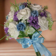 A brides bouquet of lilac, white and blue artificial flowers