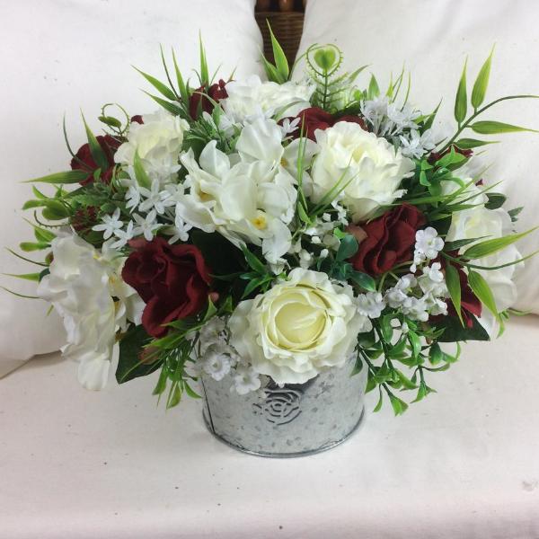 flower center piece of red and ivory roses